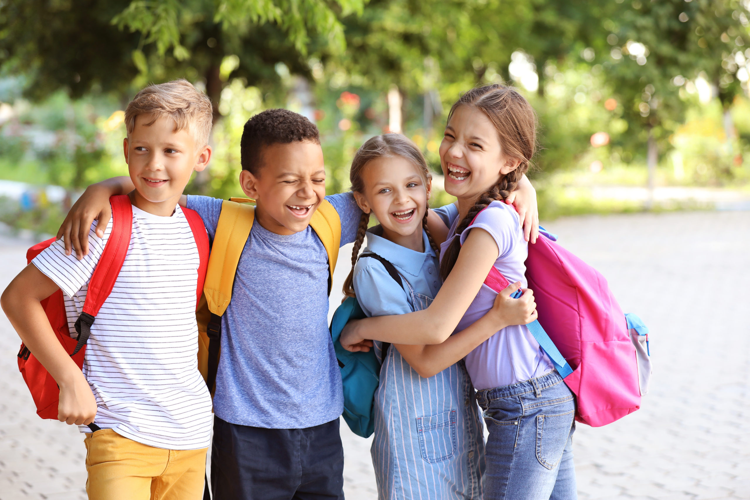 Group of cute little pupils outdoors